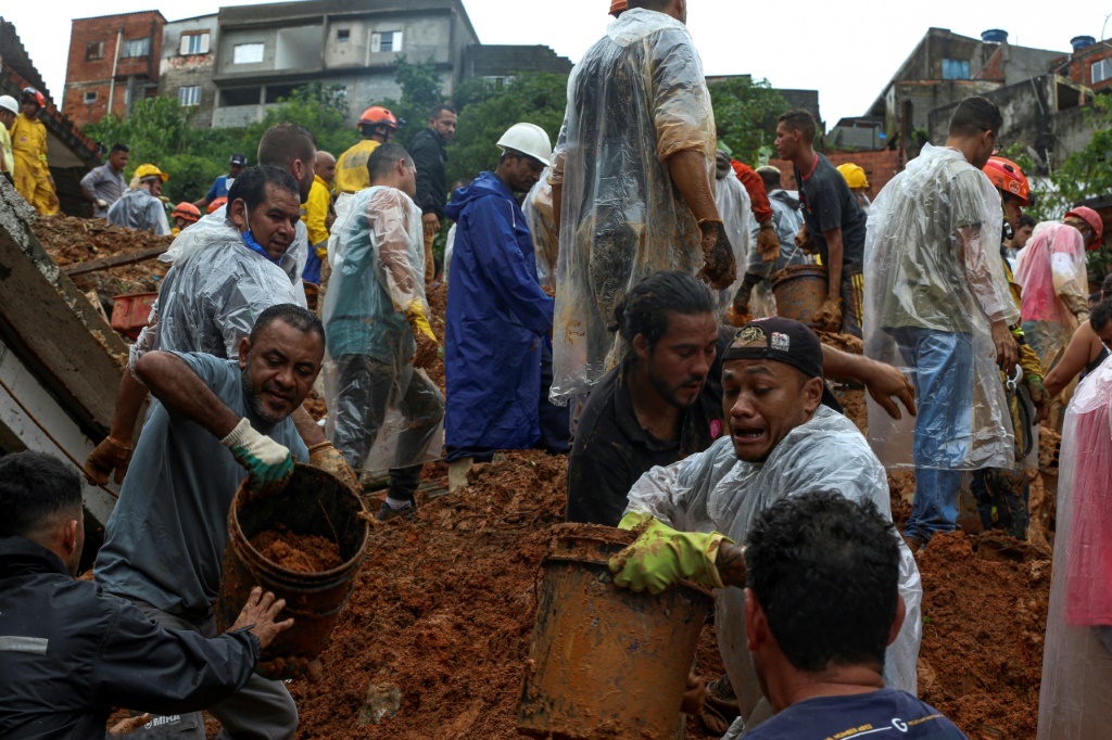 Rescuers dig desperately in mud for Brazil flood survivors