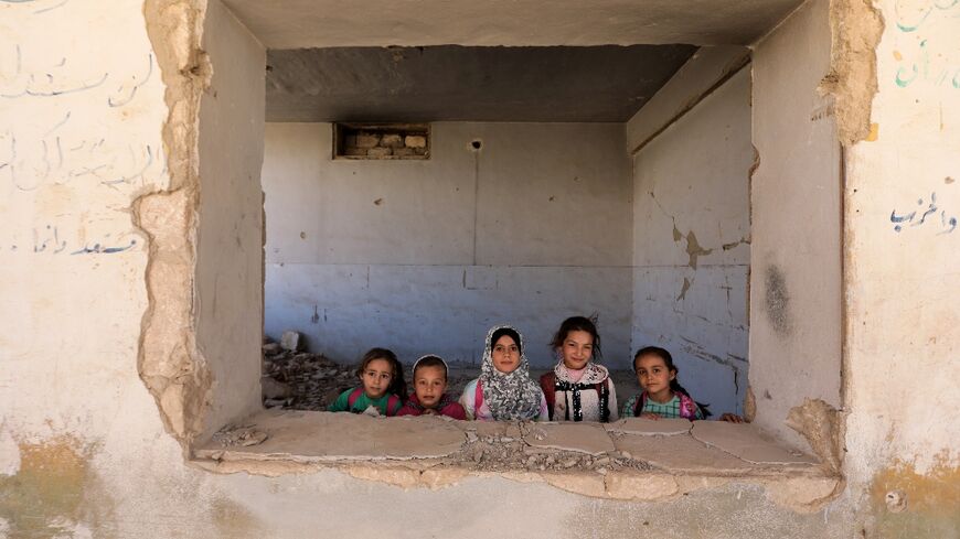 Children return to bombed-out school in Syria frontline town