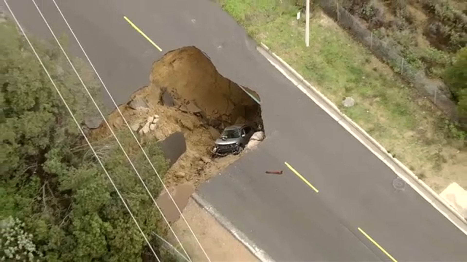 Massive sinkhole swallows two vehicles in Los Angeles