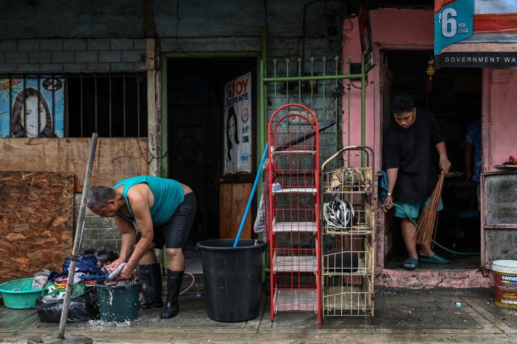 ‘Back to zero’: Manila flood victims clean up, start again